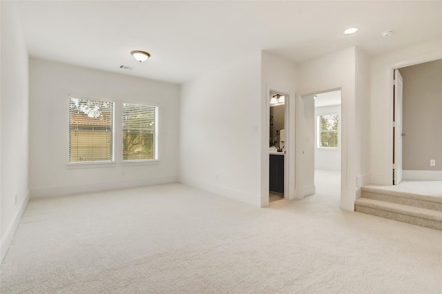 unfurnished bedroom featuring light colored carpet