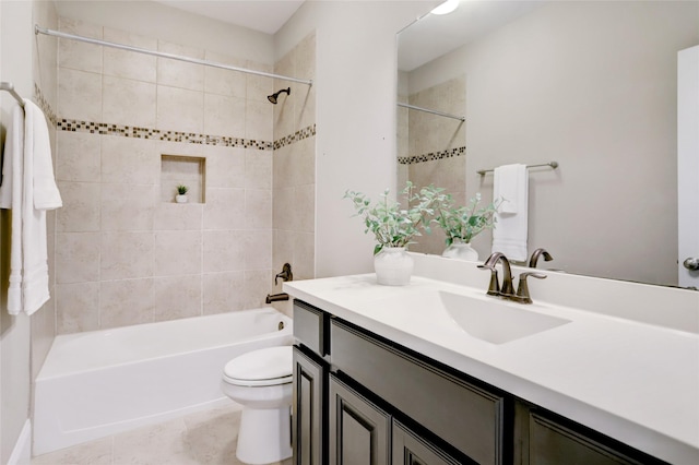 full bathroom featuring tiled shower / bath combo, vanity, toilet, and tile patterned flooring