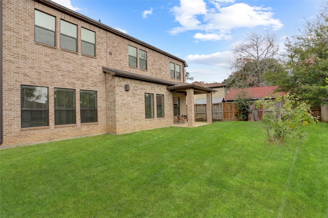 rear view of house with a yard