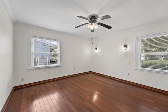 empty room featuring ceiling fan, crown molding, and wood-type flooring