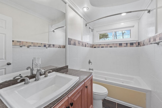 full bathroom with tile walls,  shower combination, toilet, vanity, and ornamental molding