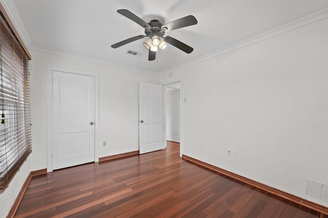 unfurnished bedroom with crown molding, dark hardwood / wood-style floors, and ceiling fan