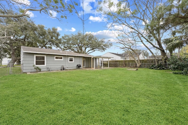 rear view of property featuring a patio area and a lawn