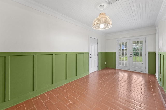 empty room with ornamental molding and french doors