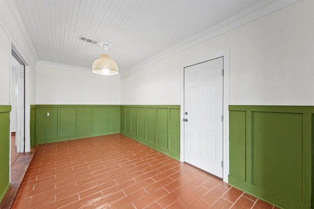 spare room featuring crown molding