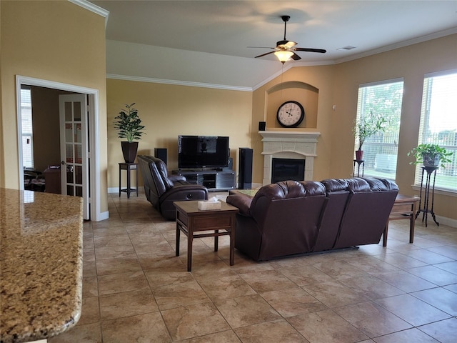 tiled living room featuring ceiling fan and ornamental molding