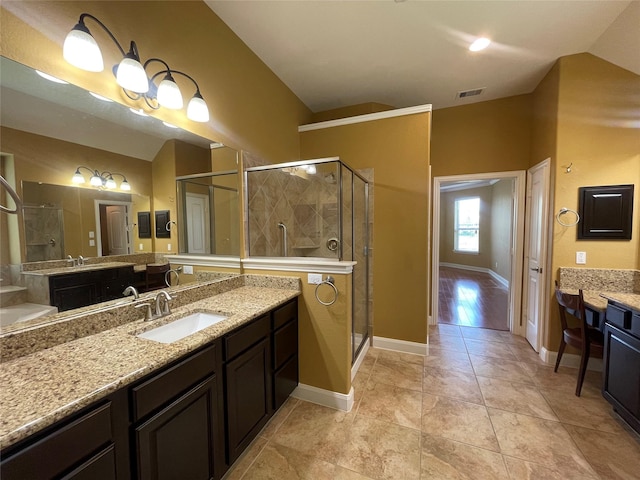 bathroom with tile patterned floors, walk in shower, and vanity