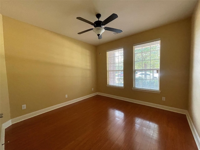 empty room featuring ceiling fan and dark hardwood / wood-style flooring