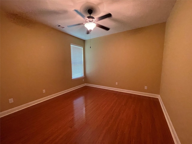 spare room featuring ceiling fan, a textured ceiling, and wood-type flooring