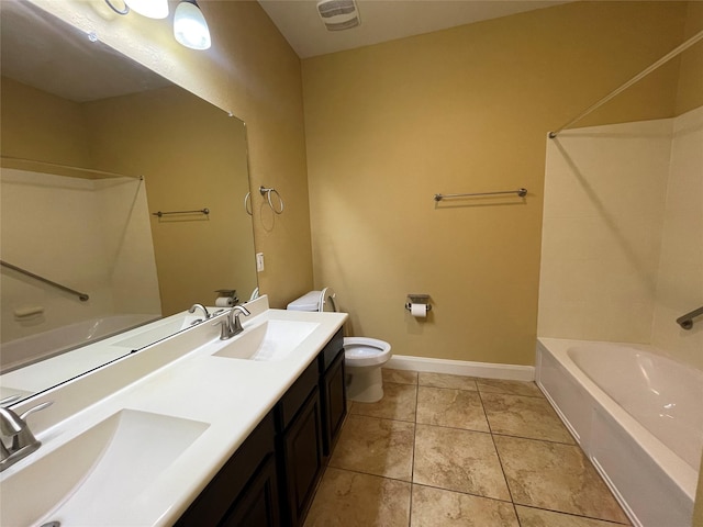 bathroom featuring a washtub, toilet, vanity, and tile patterned flooring