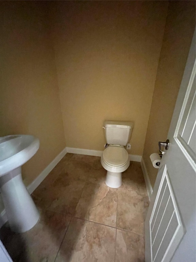 bathroom with tile patterned floors and toilet