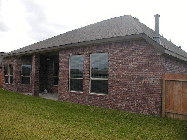 rear view of house with a yard