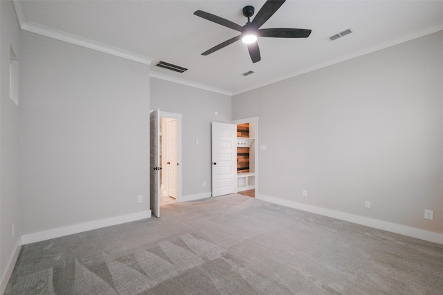 carpeted spare room featuring ceiling fan and ornamental molding