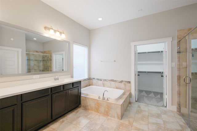 bathroom with separate shower and tub and vanity