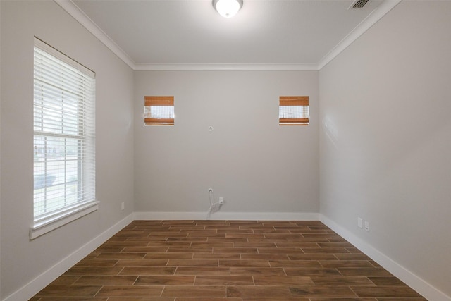 spare room with ornamental molding and dark hardwood / wood-style flooring