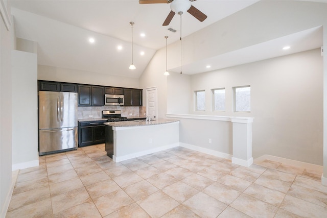 kitchen featuring pendant lighting, tasteful backsplash, light stone counters, high vaulted ceiling, and stainless steel appliances