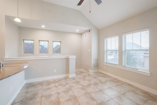 spare room featuring ceiling fan, high vaulted ceiling, and light tile patterned flooring