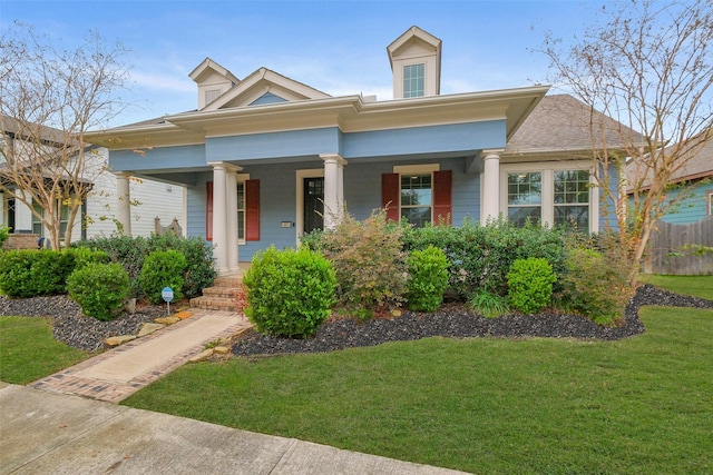 view of front facade with a porch and a front lawn