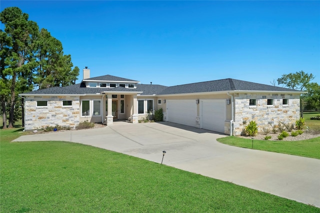 prairie-style house with a front yard and a garage