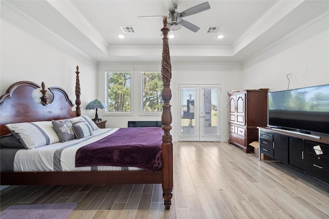 bedroom featuring crown molding, multiple windows, ceiling fan, and a raised ceiling