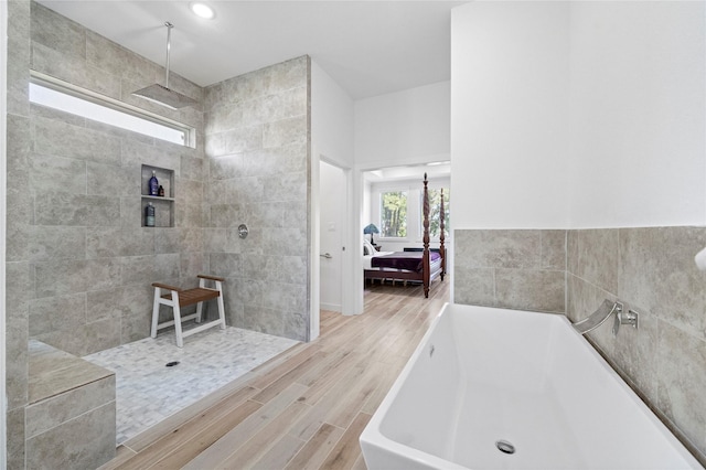 bathroom with wood-type flooring and separate shower and tub