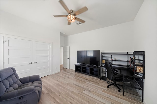 home office featuring ceiling fan and light hardwood / wood-style floors