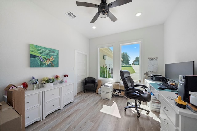 office with light wood-type flooring and ceiling fan