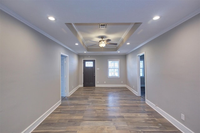 foyer entrance with ceiling fan, crown molding, dark hardwood / wood-style flooring, and a tray ceiling