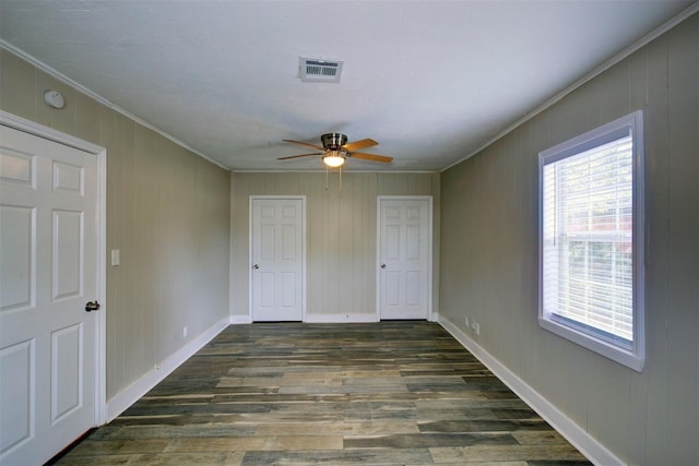 unfurnished bedroom featuring ceiling fan, ornamental molding, and dark hardwood / wood-style floors