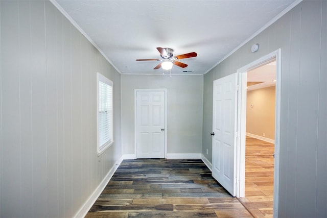 interior space with crown molding, dark hardwood / wood-style flooring, and wooden walls