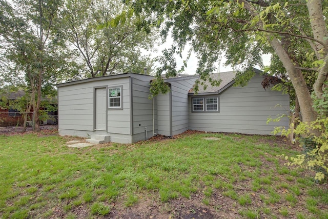 rear view of property with a yard