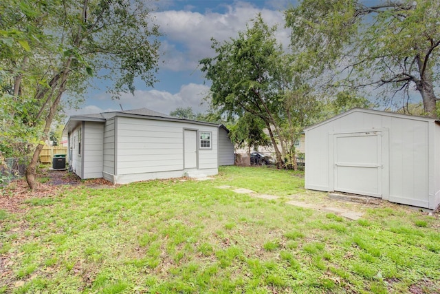 view of yard with a storage unit and central air condition unit