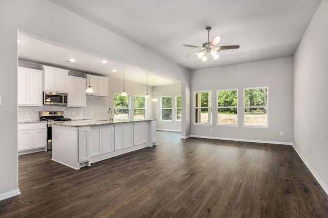 kitchen with pendant lighting, white cabinetry, a kitchen island with sink, and appliances with stainless steel finishes