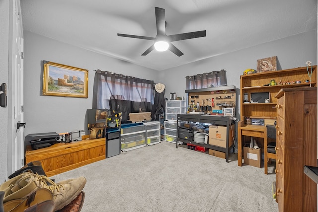 home office with ceiling fan and carpet