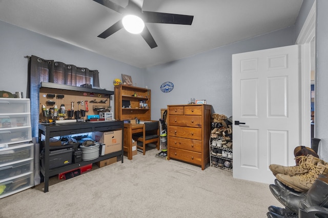 carpeted home office with ceiling fan