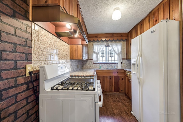 kitchen with brick wall, white appliances, decorative backsplash, dark hardwood / wood-style floors, and range hood