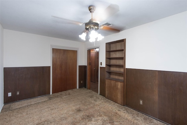 unfurnished bedroom with ceiling fan, a closet, and light carpet