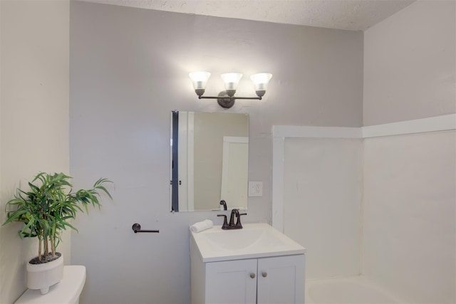 bathroom with toilet and vanity