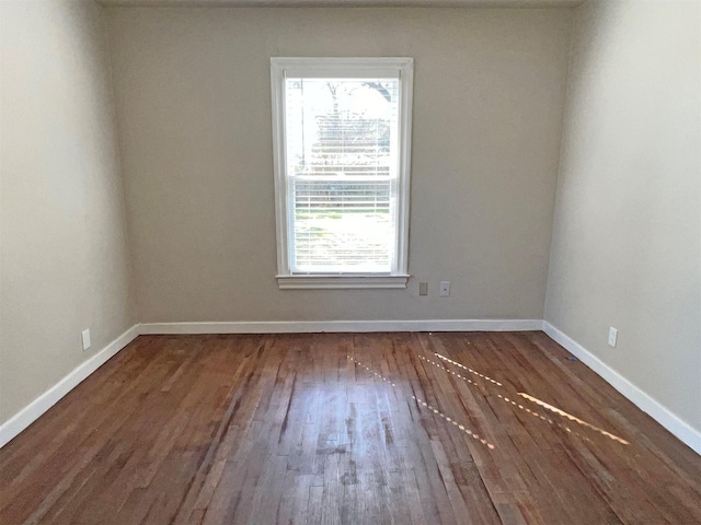 spare room with dark hardwood / wood-style floors