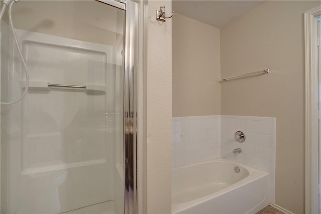 bathroom featuring separate shower and tub