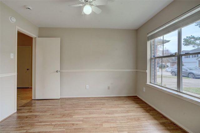 unfurnished room with a healthy amount of sunlight, light wood-type flooring, and ceiling fan