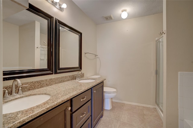 bathroom with a shower with door, toilet, tile patterned floors, and vanity