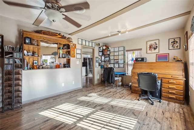 office featuring ceiling fan, hardwood / wood-style flooring, and a wealth of natural light