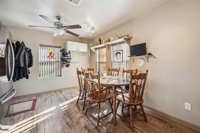 dining space with ceiling fan and hardwood / wood-style floors