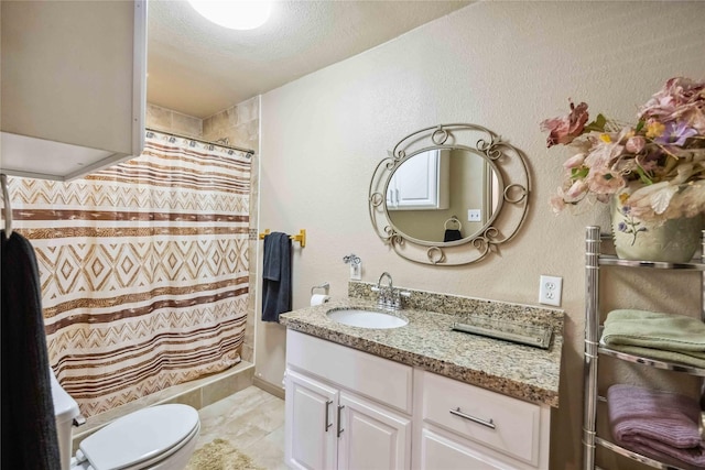 bathroom featuring vanity, toilet, walk in shower, and a textured ceiling