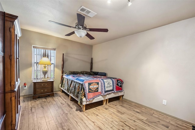 bedroom featuring ceiling fan and light hardwood / wood-style flooring