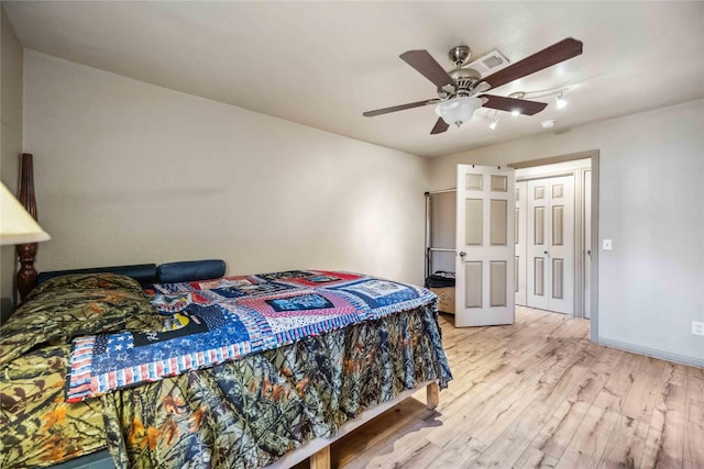 bedroom featuring a closet, ceiling fan, and light hardwood / wood-style flooring