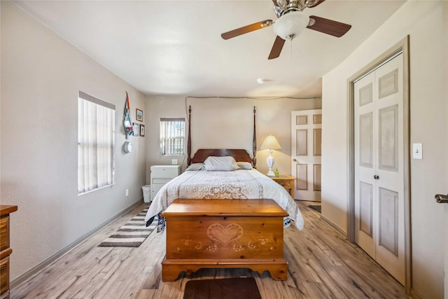 bedroom with a closet, ceiling fan, and light hardwood / wood-style floors