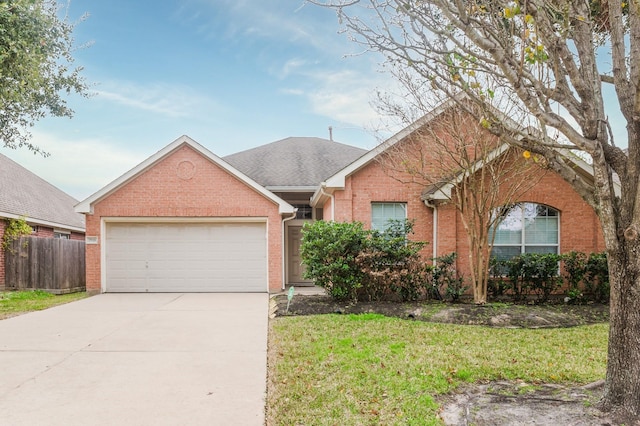 ranch-style house featuring a front yard and a garage