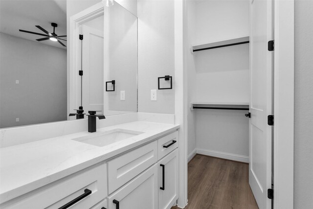 bathroom featuring hardwood / wood-style floors, ceiling fan, and vanity